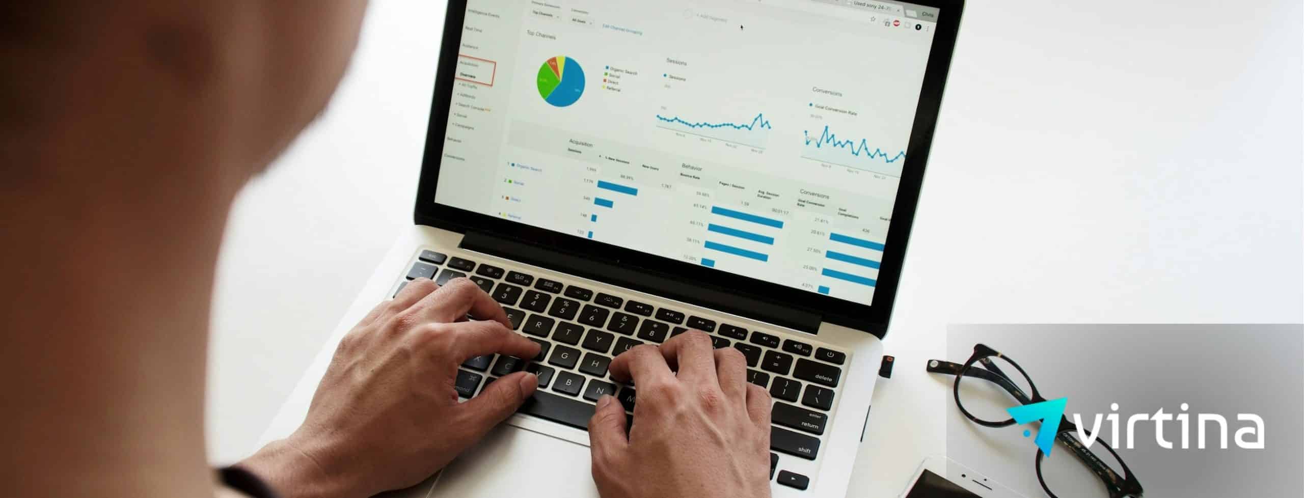 Analyst reviewing analytics dashboard on a laptop showing conversions, sessions, and channel performance for a WooCommerce B2B store