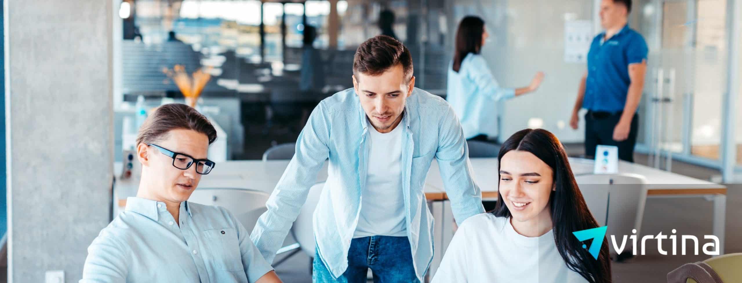 Team of three professionals collaborating in a modern open office on a WooCommerce ERP integration project